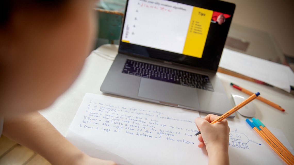 A child doing computational problems off of a laptop