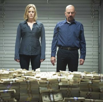 a man and a woman standing next to a pile of metal
